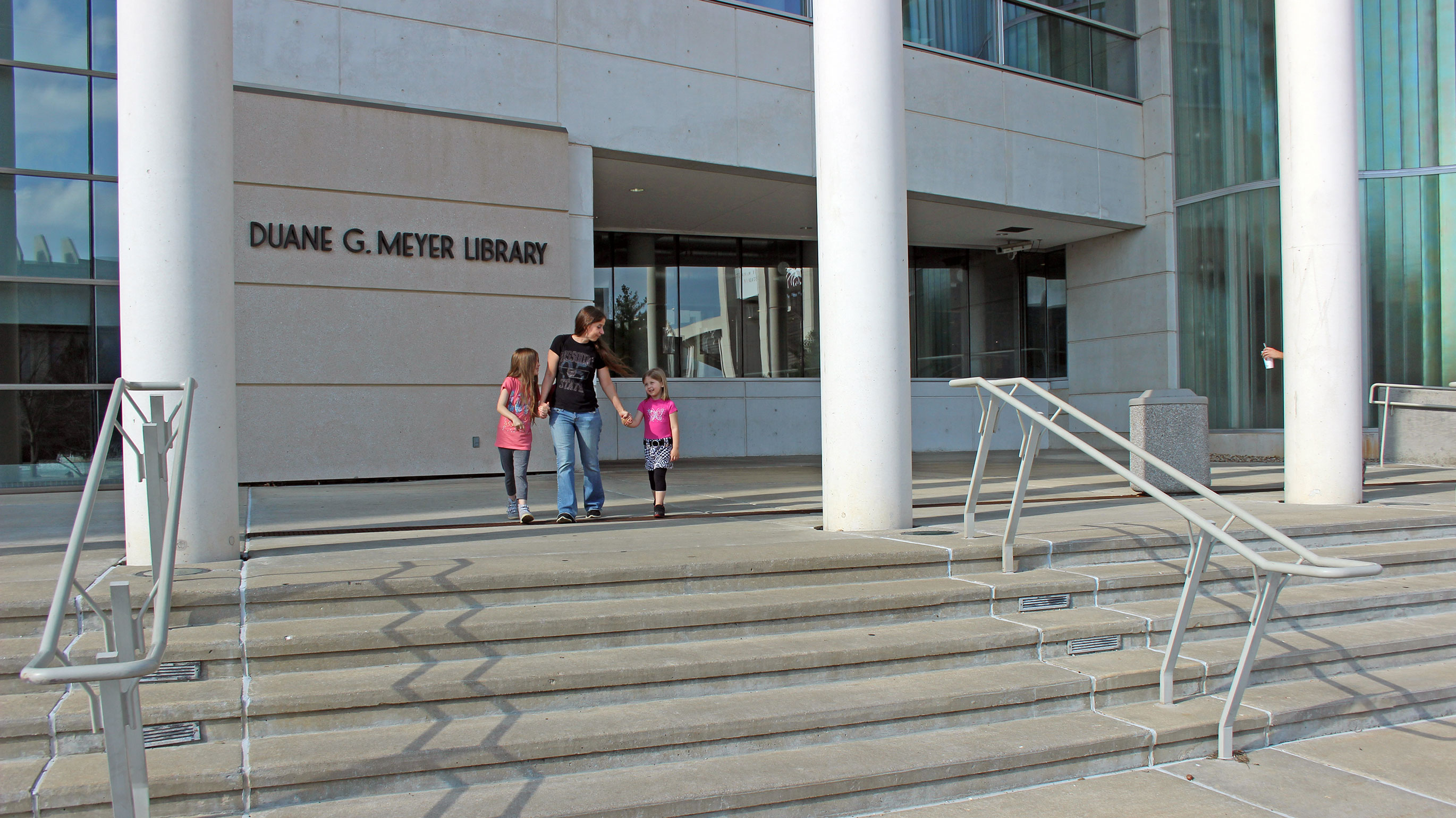 Parent with children outside of Meyer Library.