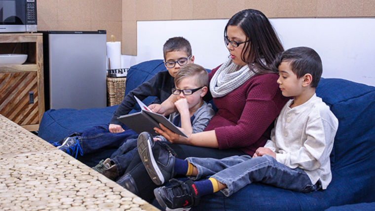 Missouri State student and mother reading to her three children. 